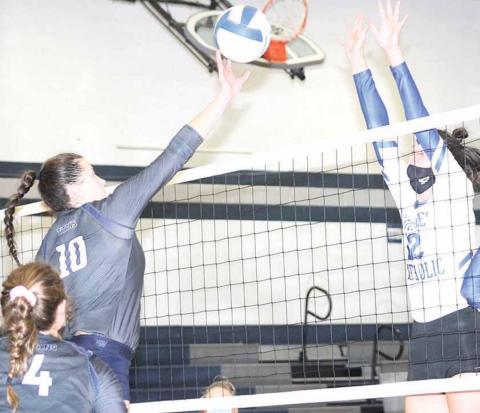 HTRS’ Jacey Leech (#10, left) tips a ball over an NCL defender as teammate Natalie Novak (#4, left) looks on in Saturday tournament action. Paula Jasa/Republican