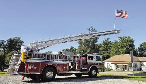 Pawnee City Firetruck hoists the American Flag on September 11th as we remember the lives lost. Photo by Betty Davis