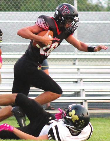 Pawnee City’s Bryce Gyhra (#26) takes the ball away from a McCool Junction rusher and returns it for a touchdown in the first half. Paula Jasa/Republican