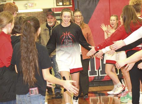 Paula Jasa/Republican P.C.’s Hallye Friedly runs through the tunnel of sportsmanship from all of the athletes who represented the Pawnee City Senior/Parent’s Night on Tuesday night in their game against Humboldt Table Rock Steinauer.