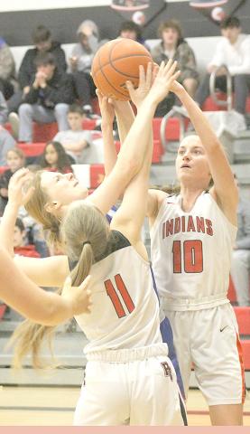 P.C.’s Cara Pierce (#11, left) and Emily Lytle (#10, right) go up for a rebound against Palmyra. Paula Jasa/Republican