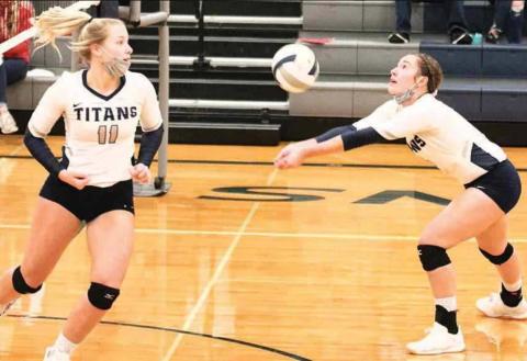 HTRS’ Natalie Novak (right) sets the ball up while hitter Katilyn Glathar (#11, left) tries to get in position to hit in the Class D1-1 subdistricts last week. photo courtesy of Lorrie Novak