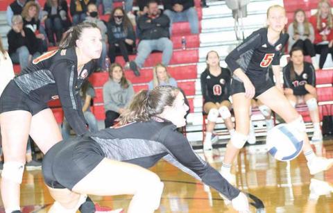 P.C.’s Larissa Tegtmeier (#6) bumps a ball to the front row as teammates Austin Branch (left) and Sierra deKoning (#5, right) look to help. Paula Jasa/Republican