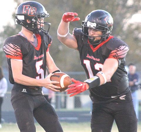 P.C.’s Justin Pierce (#5, left) fakes a handoff to Andy Maloley (#12, right) before throwing a TD pass. Paula Jasa/Republican