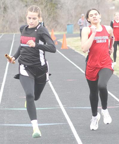 Paula Jasa/Republican P.C.’s Emily Lytle (left) passes a Johnson-Brock runner at the end of the 1600 M. Relay to win with a time of 4:37.08.