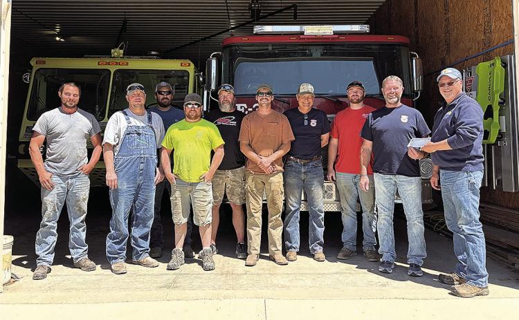 Jeff Wehrbein, Farmers Cooperative Burchard Location Manager presents grant check to DuBois Fire Department members.