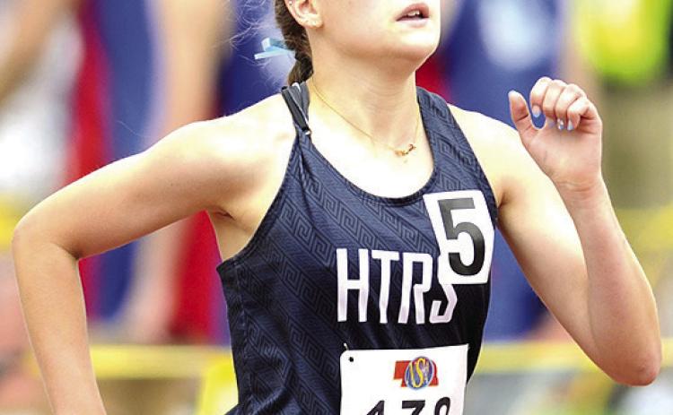 HTRS’ Grayson Sherman runs her leg of the Class D girls’ 3200 M. Relay on Friday. The Lady Titans made it to the podium with their school record time of 10:15.56. Photo courtesy of Luke Nichols/Beatrice Daily Sun