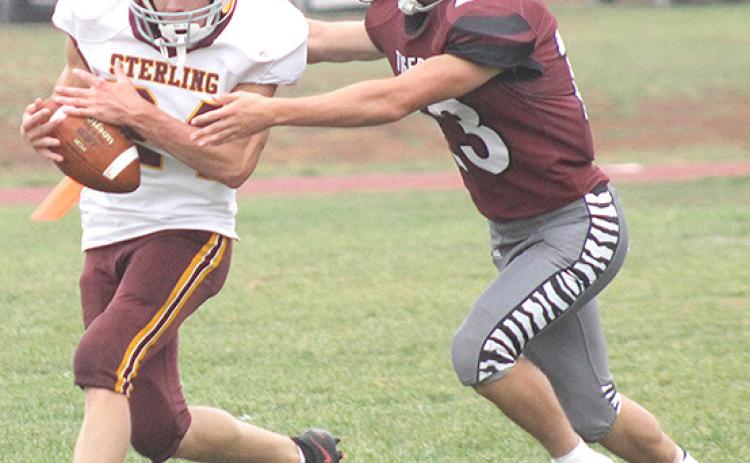 LHS’ Kaden Wagner (#23, right) makes a good tackle on a Sterling runner. Wagner had some great stops in the game including a touchdown-saving tackle. Paula Jasa/Republican