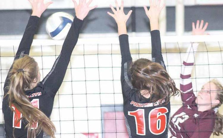 P.C.’s Madison Branek (#11, left) and Reyana Tegtmeier (#16, right) team up at the net against Sterling in Thursday night triangular action. Paula Jasa/Republican