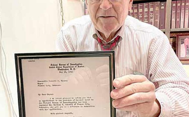Pawnee City attorney Joe Stehlik holds up the letter from J. Edgar Hoover announcing that Judge William F. Colwell was appointed to serve in the FBI. Ray Kappel/Republican