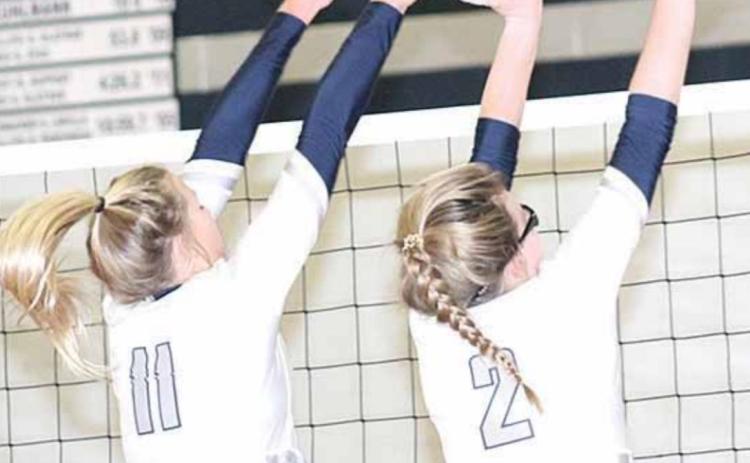 HTRS’ Katilyn Glathar (#11, left) and Aly Howe (#2, right) get their hands on a double ace block. Paula Jasa/Republican
