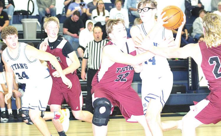 Paula Jasa/Republican HTRS’ Gage Schaardt (#14, center) draws a crowd of Lewiston players including Tristen Ray (#24, right) and Ty Arena (#32, center) as teammates Andrew Stalder (#34) and Caleb Rule (left) look on. Pictured right is LHS’ Brady Bledsaw against Stalder.