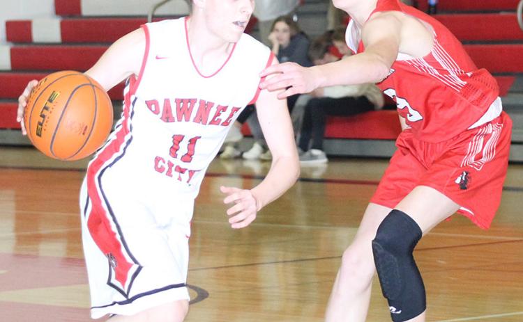 P.C.’s Brysen Horst (#11, left) drives past a surprised Weeping Water defender in a game before the Holiday break. Horst scored 10 points against Weeping Water. Paula Jasa/Republican