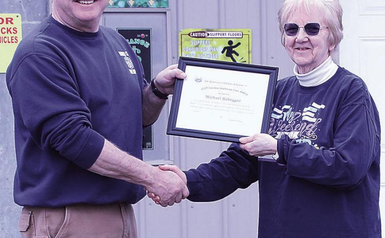 Lola Seitz (right) presents Mike Habegger (left) with the Carolyn VanHorne Civic Award