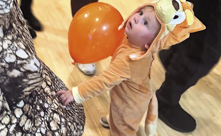 Zoey Rohrs of Du Bois (She’s checking out the dinosaur next to her to see if it is real!)