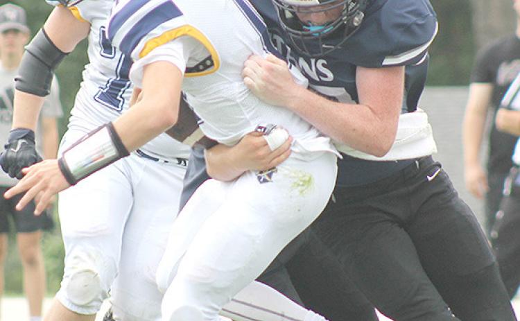 HTRS’ Colt McClarnen (#27, right) sacks the Omaha B-T quarterback on Saturday. McClarnen had 3 tackles and 1 sack in the 70-64 victory over the Raiders. Paula Jasa/Republican