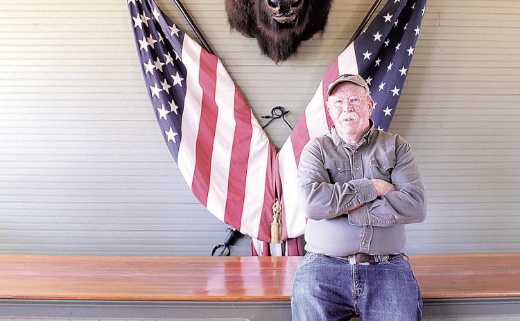 Jim Tegtmeier in his store with his prized buffalo head