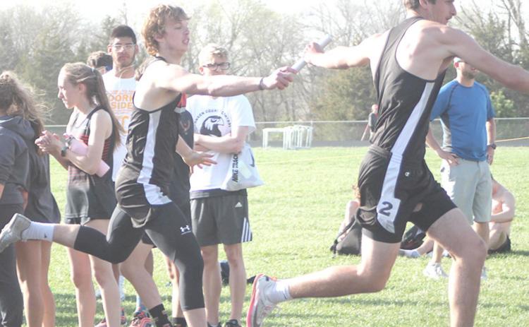 P.C’s Kyle Gyhra hands off to teammate Bryce Gyhra in the boys’ 1600 M. Relay. photo courtesty of Ann Wickett