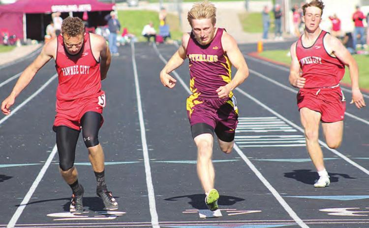 Pawnee City’s Jacob Lytle (left) finishes a close 2nd to Sterling’s Derek Buss (center) while P.C. teammate Andy Maloley (right) takes 3rd in the 200 M. Dash. Lytle qualified for four events for the 2021 State Track Meet at the Class D-1 Districts. Paula Jasa/Republican