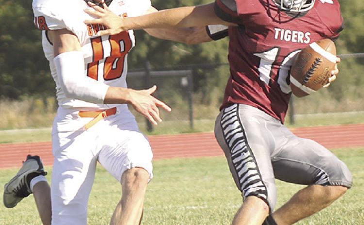 LHS’ Everett Bohling (#10, right) eludes a Griffin tackler and rolls back to the right side of the field to complete a touchdown pass right before the halftime break. Paula Jasa/Republican