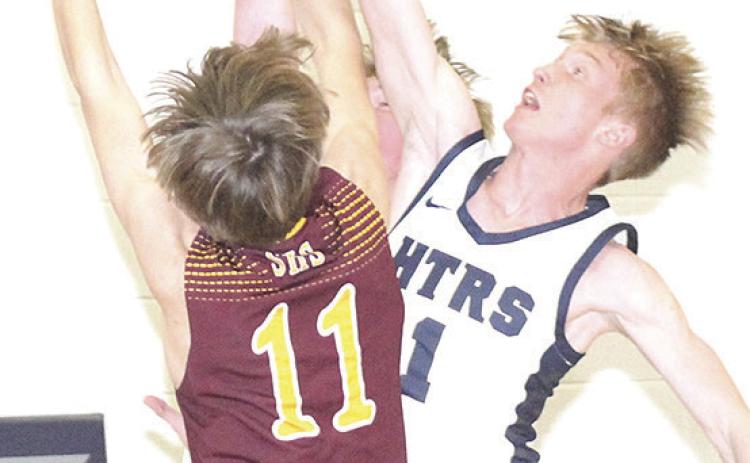 HTRS’ Brogan Dunlap (#1, right) gets his hand on a block against a Sterling shooter on Friday night. Paula Jasa/Republican