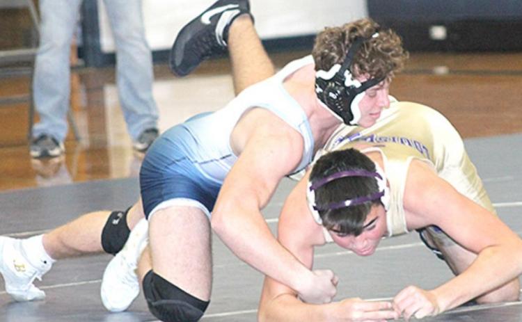 HTRS/P.C’s Andy Maloley dominates his Louisville opponent at the Titan’s home double dual on Thursday. Paula Jasa/Republican