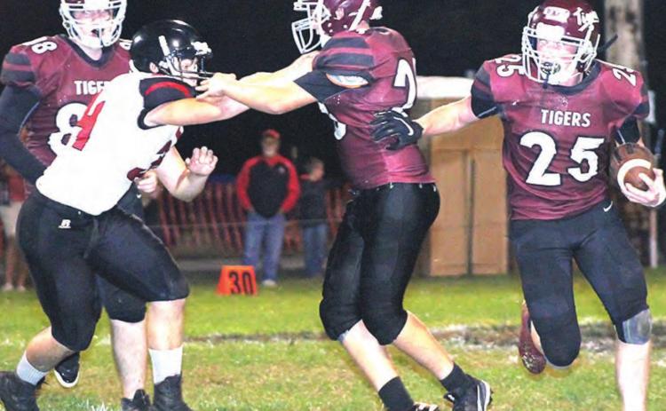 Lewiston’s Tristen Ray (#25 right) runs behind his blocker Everett Bohling (#23, center) while teammate Freddie McMurray looks on. Ray led Lewiston with 22 carries for 103 yards against Meridian. Paula Jasa/Republican