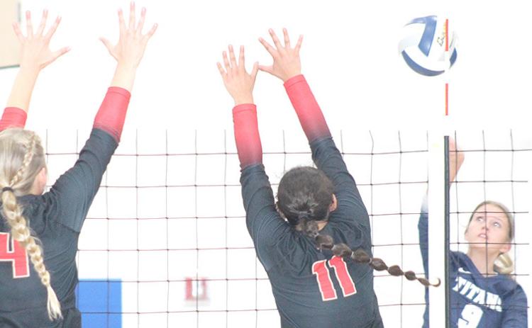 HTRS’ Avery Dierberger (#9, right) puts down a cross court kill against JCC’s Sunnie Rother (#4, left) and Arely Cabrelas (#11, right) in Thursday’s match. Paula Jasa/Republican