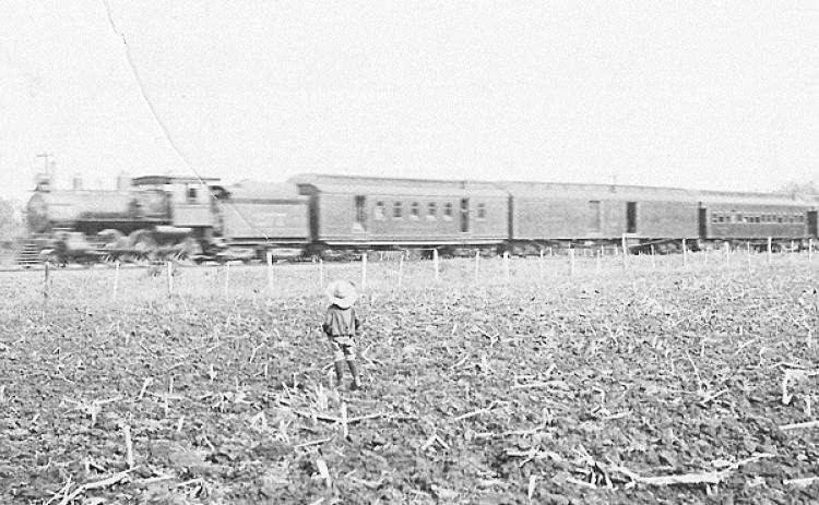 Above: Emory Purcell, a member of the Table Rock family of Jack and Ida Purcell, watches a train go by, probably one of the cannonballs between Kansas City and Denver. This is a Purcell family photo shared by Terry Korell of Lingle, Wyo-ming.