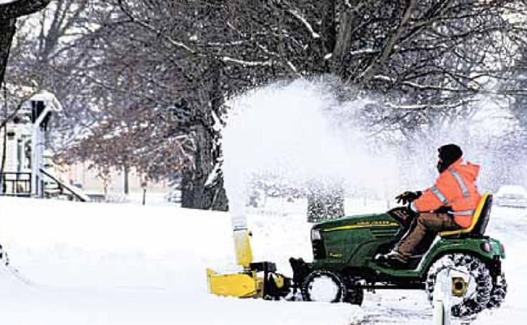Travis Karbowksi of the Pawnee Village maintenance staff clears sidewalks Monday. Ray Kappel/Republican