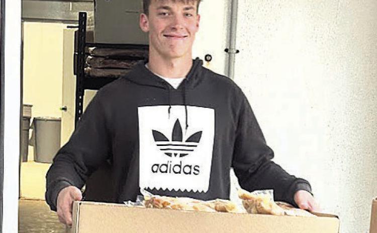 Eli Boellstorff of Auburn exits freezer with part of customer’s processing order