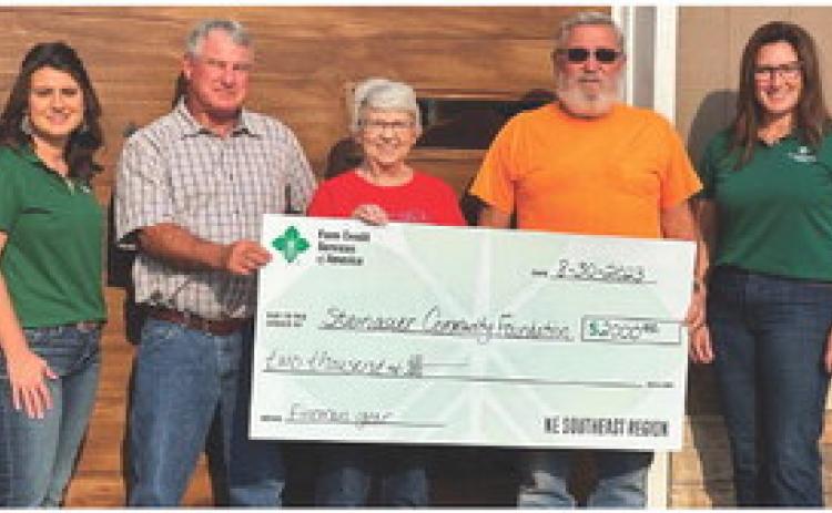 Presenting/Receiving the check, Farm Credit Representative, April McHenry; Steinauer Fireman, Terry Wenzl; Steinauer Community Foundation Board Member, Marie Schmit; Steinauer Fireman, Byford Schmit; Farm Credit Representative, Jessi Larson.