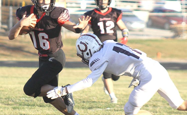 P.C.’s Anthony Kling (#16, left) returns a kickoff early against Stuart in the Class D6 State Football playoffs as teammate Andy Maloley (#12, right) looks on. Paula Jasa/Republican