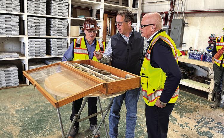 NioCorp executives Scott Homan (left) and Mark Smith (right) showcase rare earth samples to Congressman Adrian Smith (center).