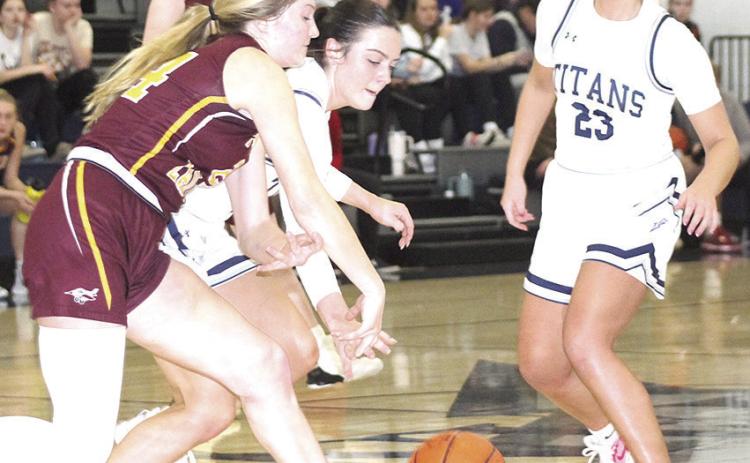 HTRS’ Lillian Bowen (center) goes for a loose ball against Sterling as teammate Jaylie McNealy (#23, right) looks to help out. The Lady Titan defeated the Lady Jets on Friday night by a 48-38 score. Paula Jasa/Republican