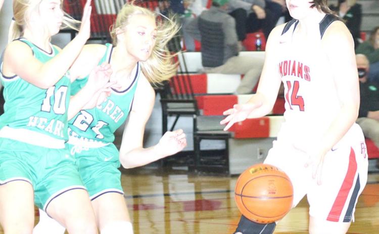 P.C.’s Reyana Tegtmeier (#14, right) gets double teamed by FCSH Lady Irish defenders as she brings the ball down the court on Friday night. Paula Jasa/Republican