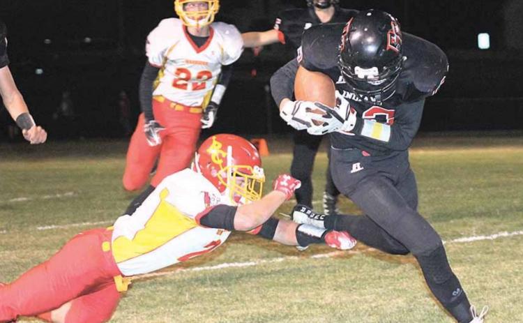P.C.’S Kyle Gyhra (#22, right) keeps a handle on the ball while busting through tackles on this 45 yard touchdown run in the 2nd quarter. Paula Jasa/Republican