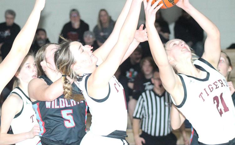 Paula Jasa/Republican LHS’ Carleigh Weyers (center) and Madeline Janssen (#21, right) fight for a rebound in the early going against Cedar Bluffs. Lewiston won easily, 66-16.