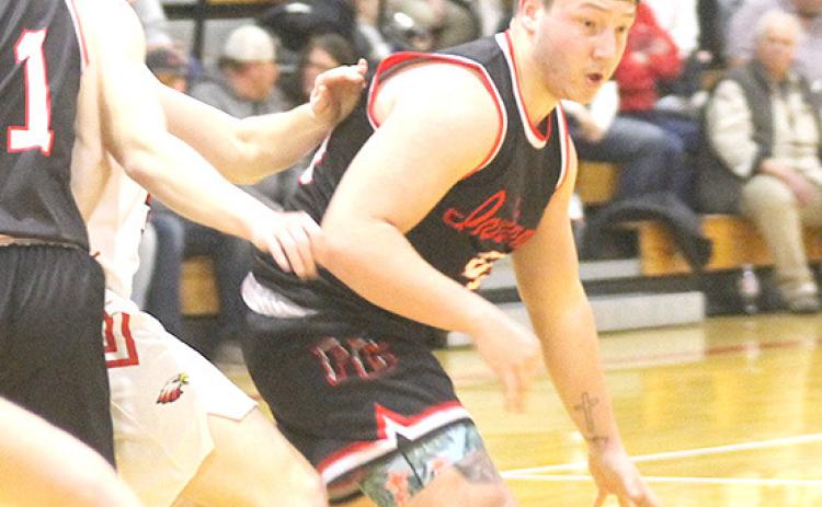 P.C.’s Joey Marteney (right) drives past a J-B defender in the D1-1 subdistrict final. Marteney scored 10 points and had 5 rebounds, 2 steals and 1 block in the game. Paula Jasa/Republican