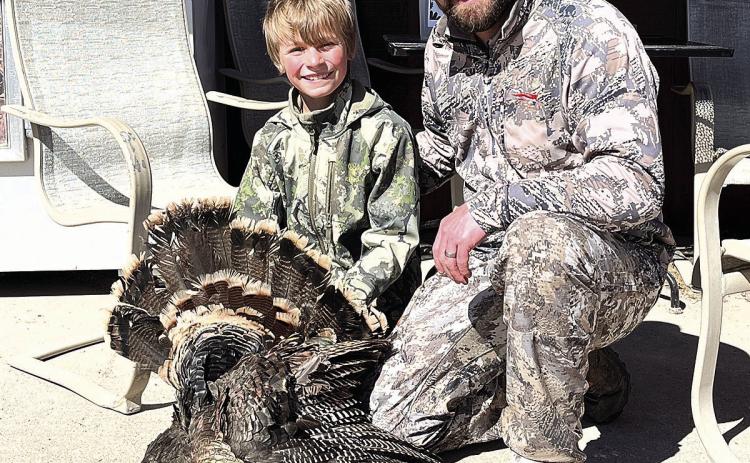 Colton Sedivy (left) and his dad pose with the first bird of Colton’s two birds
