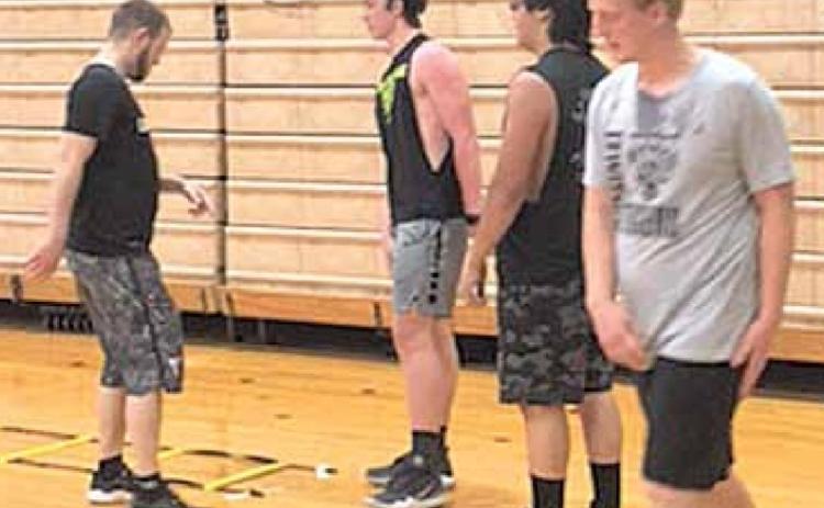 Working on summer conditioning at Lewiston are from left, Coach Kyle Asche, Hayden Christen, Cayd Wilgers, and Jon Janssen