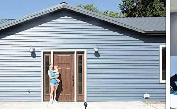 Amanda Niss holds Cal outside the new daycare facility. Right: Amanda Niss with Cal inside the daycare facility, here in the Reading Nook. Ray Kappel/Republican