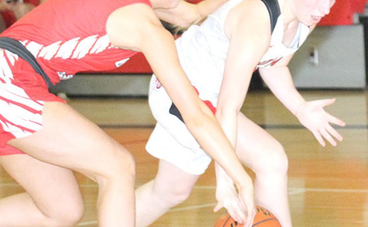 P.C.’s Cara Pierce (right) picks up a steal against Weeping Water. Paula Jasa/Republican