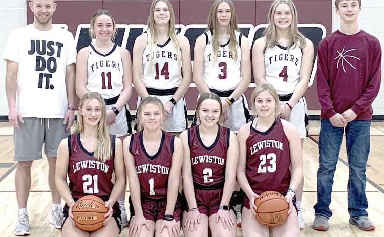 Members of the 2022-23 Lewiston Girls’ Basketball Team are front, from left: Maddie Janssen, Ayden Hunzeker, Jenna Anderson, DeLayne Currie. Back row, from left: Head Coach Kyle Asche, Carleigh Weyers, Meagan Sanders, Katelyn Sanders, Emma de Koning, Payton Heideman, s.m. Not pictured: Asst. Coach Alex Callan, Leah Christen, Justice Currie, s.m.