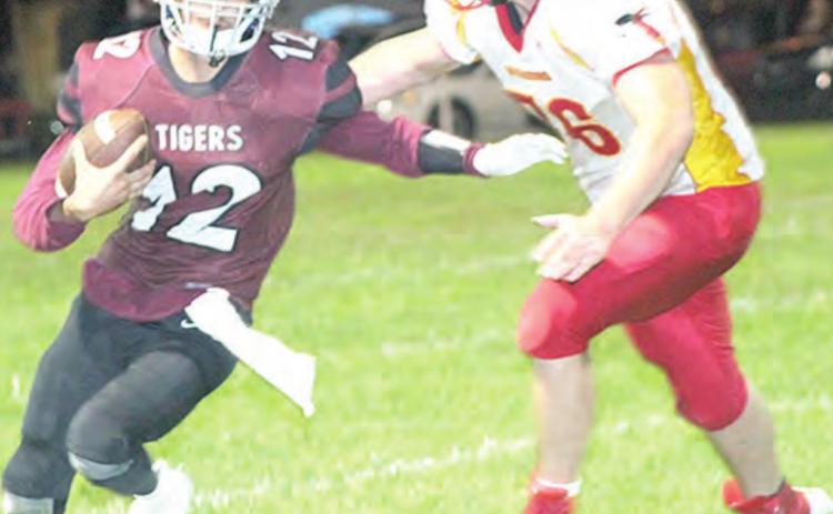 Lewiston’s Abel Gonzalez (#12, left) avoids a Red Cloud tackler on his way to the end zone. Paula Jasa/Republican