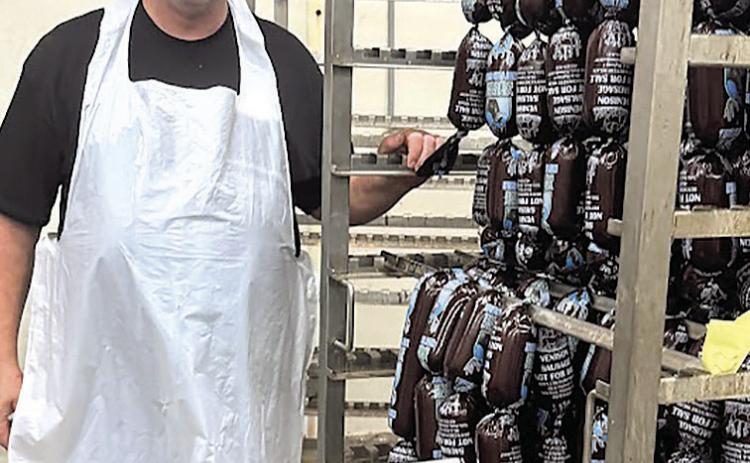 Den Schaardt with 400 pound cart of deer sausage headed for smoker.
