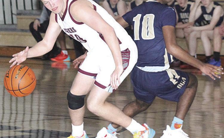 LHS’ Everett Bohling (#10, left) fakes out his OCA opponent on his way down the court. Bohling scored 20 points to lead the Tigers in Saturday’s game. Paula Jasa/Republican