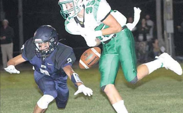 HTRS’ Donovan Kostecka (#2, left) knocks down a PAT pass early in the game. Paula Jasa/Republican