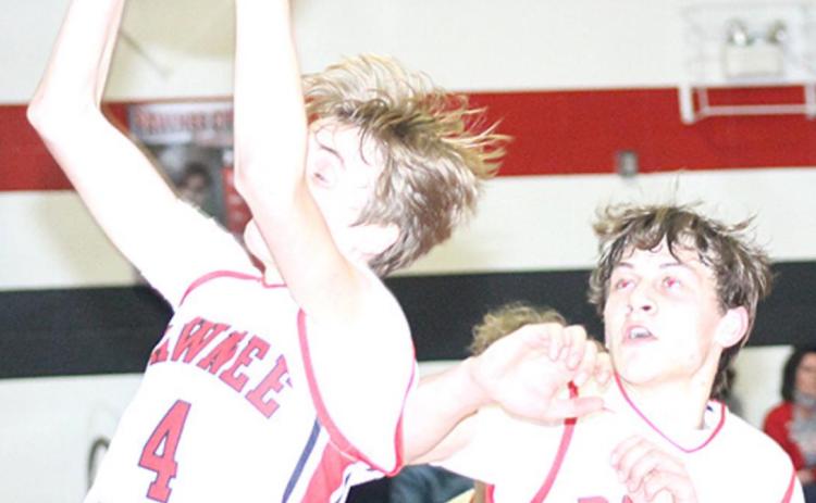 P.C.’s Kylenn Koester (#4, left) pulls in a late rebound as teammate Kaden Lang (#15, right) looks on. Paula Jasa/Republican