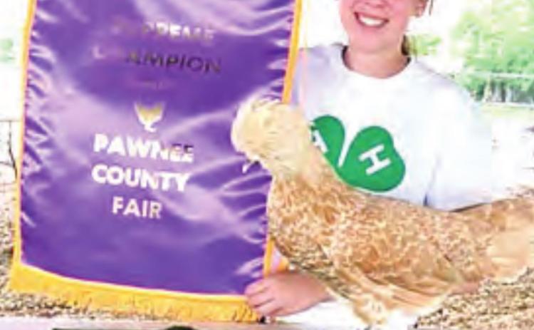 Lauren Moser with her Buff Laced Polish hen supreme champion of poultry show last year